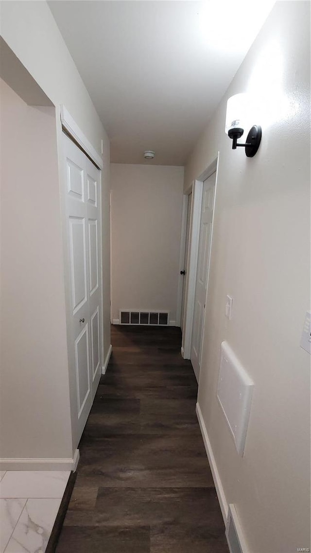 hall with baseboards and visible vents