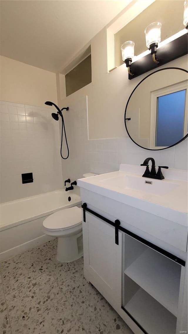 full bath featuring toilet, vanity, tile walls, and shower / bathtub combination