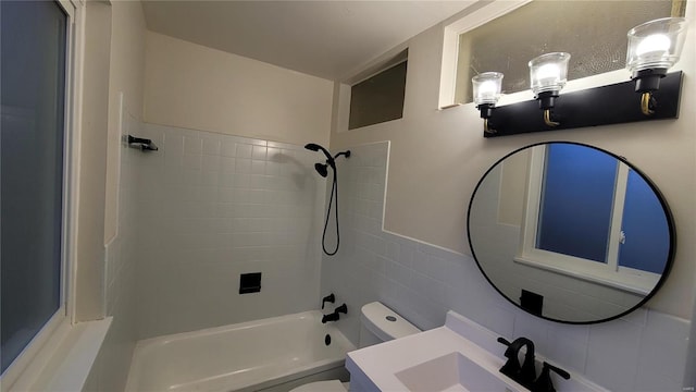 bathroom featuring toilet, shower / tub combination, and vanity