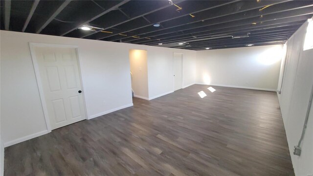 finished basement with dark wood-style floors and baseboards