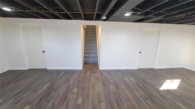 finished basement featuring dark wood-style floors and baseboards