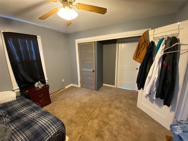 bedroom featuring a closet, carpet flooring, a ceiling fan, and baseboards