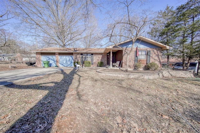 view of front of house with brick siding, driveway, and an attached garage