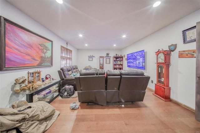 living room featuring recessed lighting, baseboards, and light wood finished floors