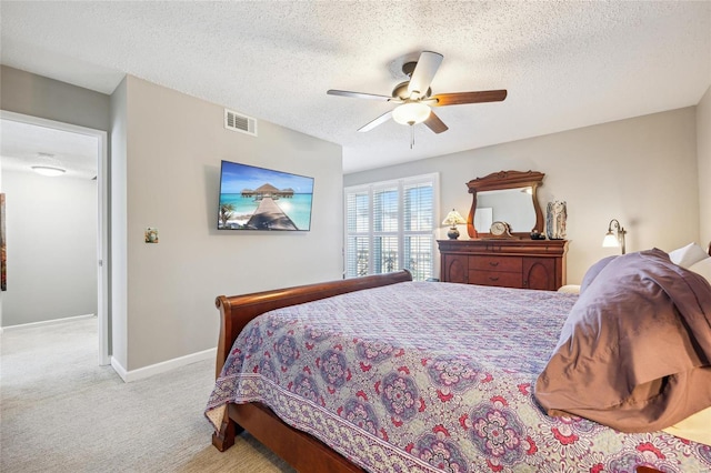 bedroom featuring carpet, visible vents, ceiling fan, a textured ceiling, and baseboards