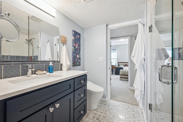 full bath with toilet, a stall shower, a textured ceiling, and visible vents