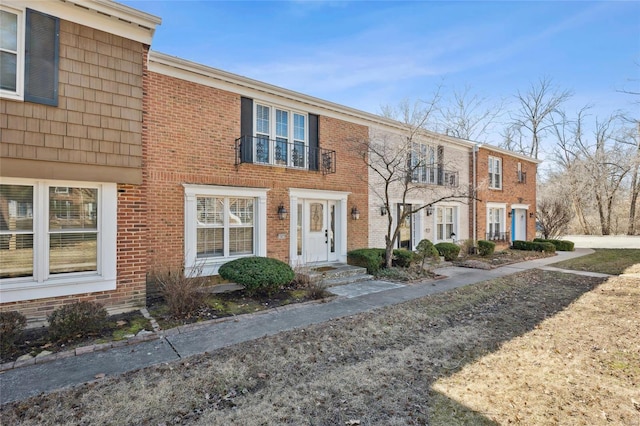 townhome / multi-family property featuring brick siding