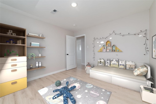 living area featuring visible vents, baseboards, and wood finished floors