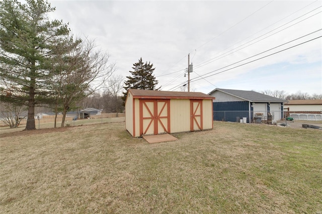 view of shed featuring fence