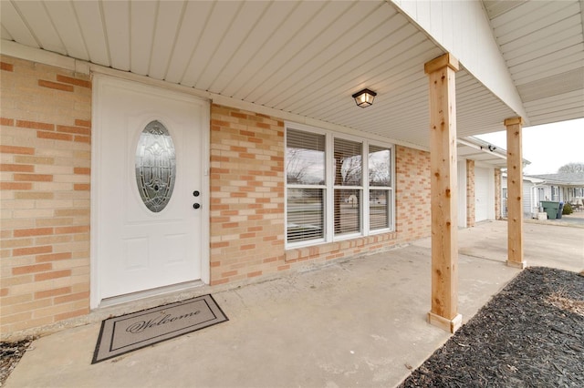 property entrance featuring brick siding