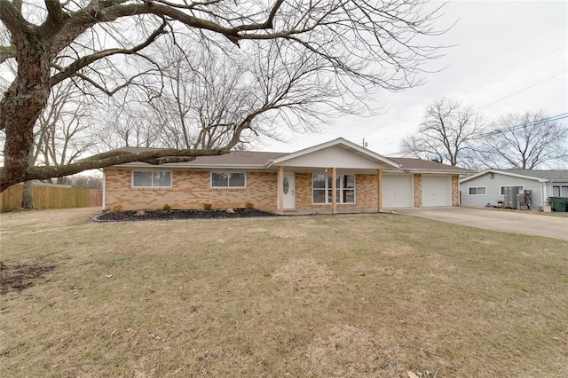 ranch-style home featuring an attached garage, brick siding, fence, concrete driveway, and a front yard