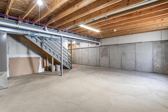 unfinished basement featuring stairs