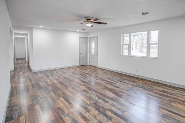 unfurnished room featuring ceiling fan, recessed lighting, dark wood-type flooring, visible vents, and baseboards