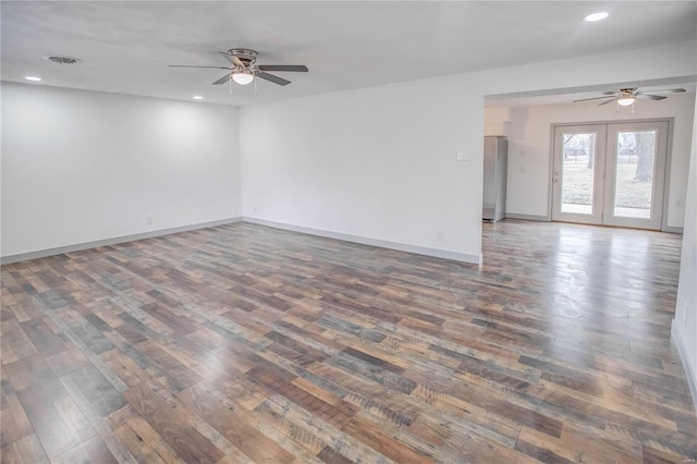 spare room featuring dark wood-style flooring, recessed lighting, visible vents, and baseboards