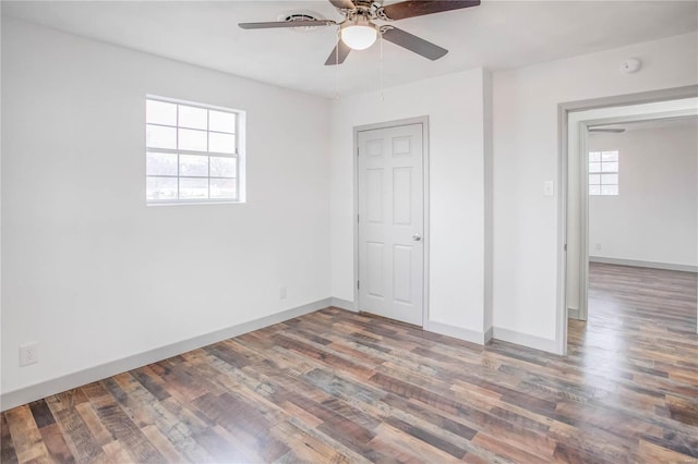 unfurnished bedroom with ceiling fan, baseboards, and wood finished floors