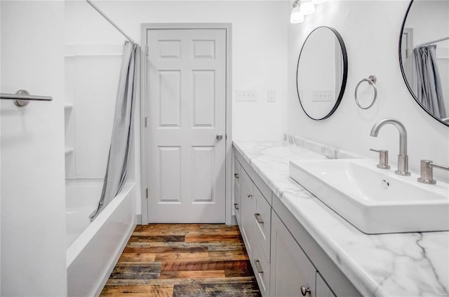 full bathroom with shower / tub combo, wood finished floors, and vanity