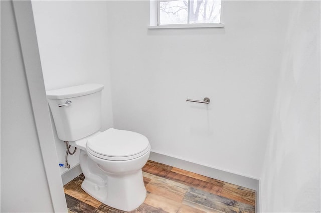 bathroom with toilet and wood finished floors