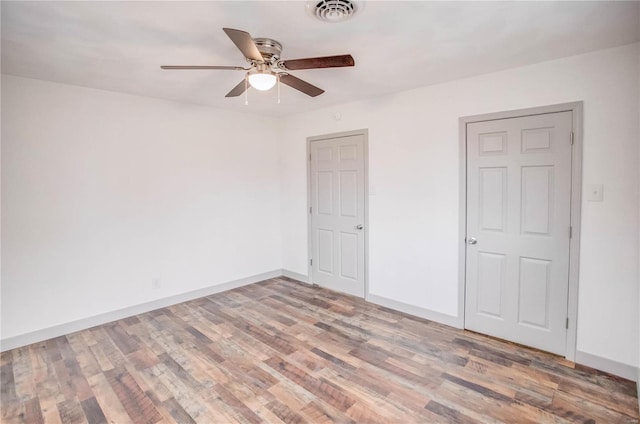 unfurnished bedroom featuring visible vents, ceiling fan, light wood-style flooring, and baseboards