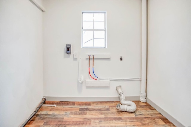 laundry room with washer hookup, hookup for an electric dryer, wood finished floors, laundry area, and baseboards