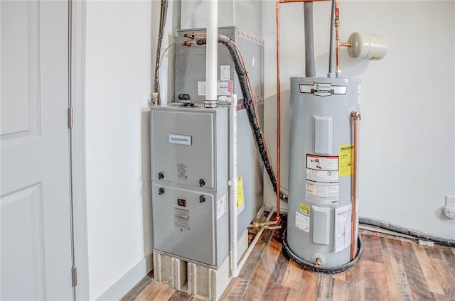 utility room featuring water heater and heating unit