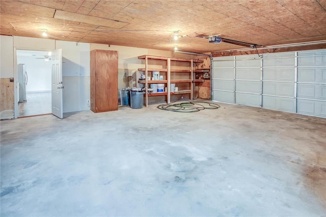 garage with freestanding refrigerator and a garage door opener