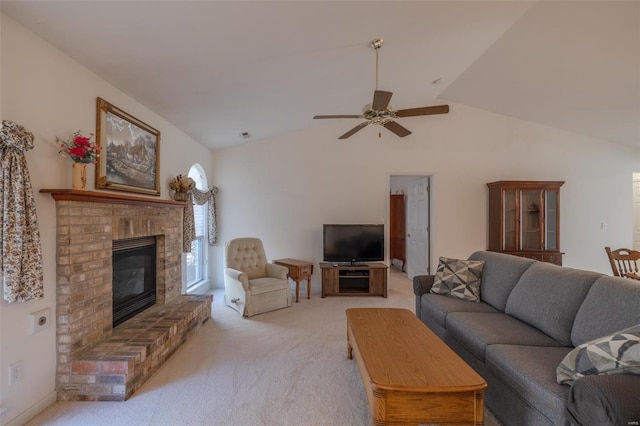 living area featuring lofted ceiling, light carpet, a fireplace, and ceiling fan