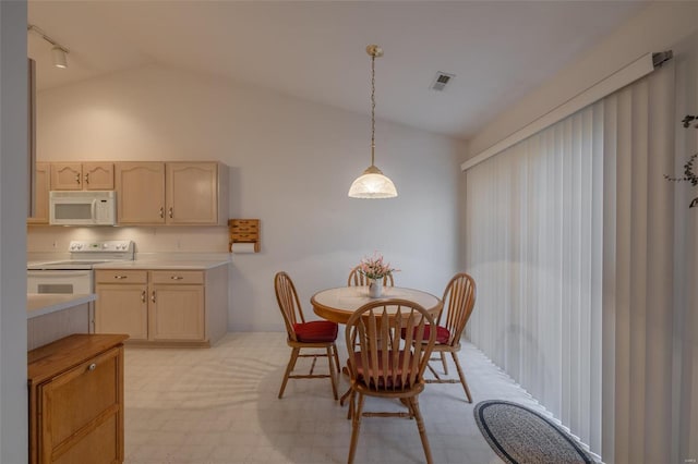 dining room featuring visible vents and vaulted ceiling