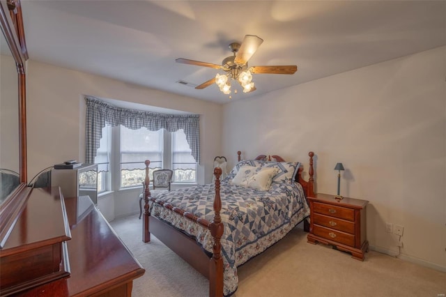 carpeted bedroom featuring visible vents, ceiling fan, and baseboards