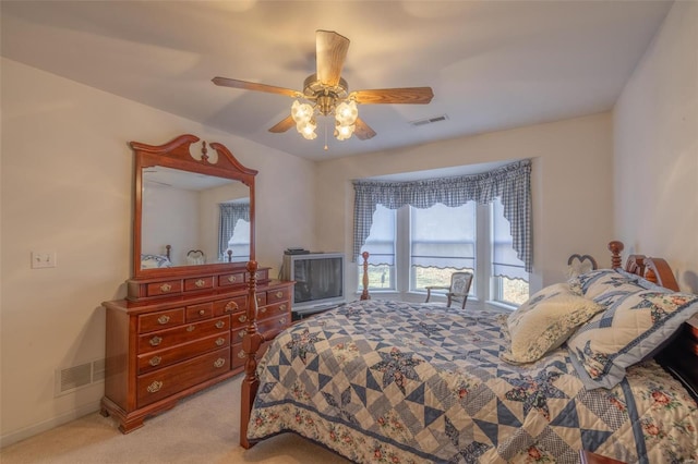 bedroom with a ceiling fan, visible vents, light carpet, and baseboards