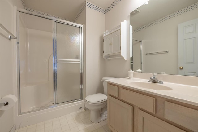 bathroom with toilet, a shower stall, tile patterned flooring, and vanity