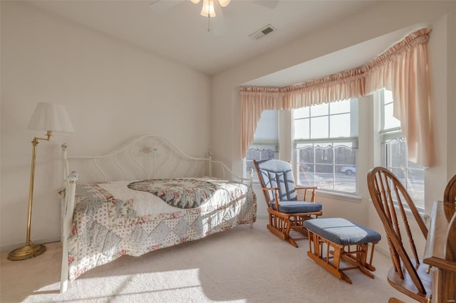 bedroom featuring carpet floors, visible vents, and a ceiling fan