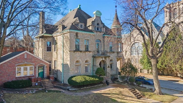 view of front facade featuring stone siding, a chimney, and a high end roof