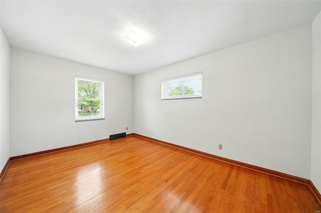 spare room with plenty of natural light and light wood-type flooring