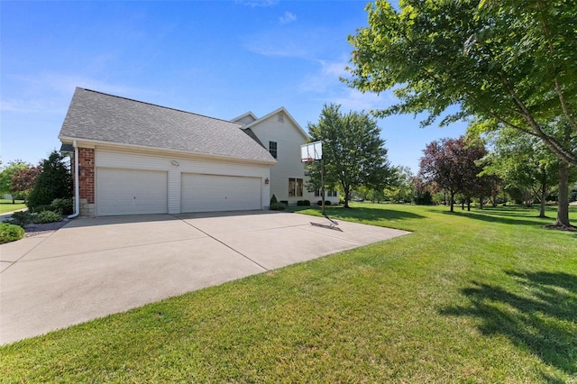 view of side of home with driveway, a yard, an attached garage, a shingled roof, and brick siding