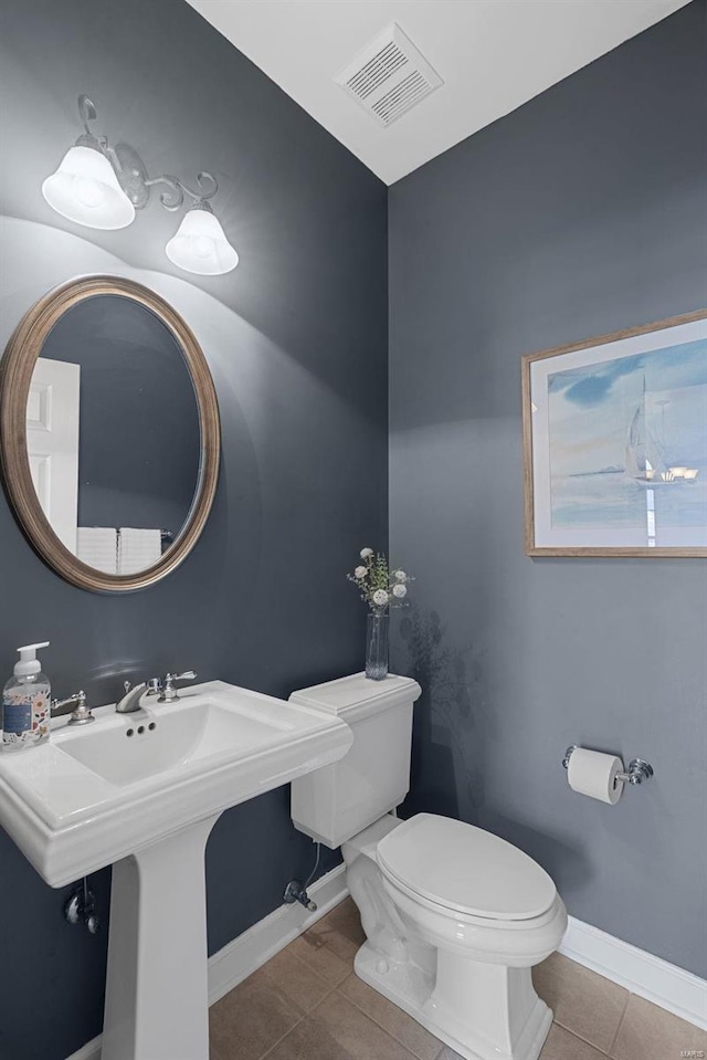 bathroom featuring visible vents, baseboards, toilet, and tile patterned flooring