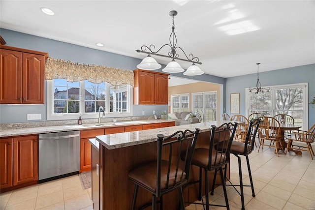 kitchen with a center island, dishwasher, an inviting chandelier, hanging light fixtures, and a sink