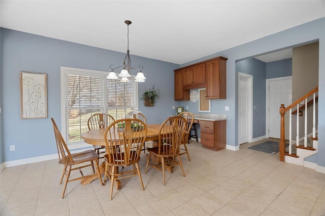 dining space featuring an inviting chandelier, stairway, light tile patterned floors, and baseboards