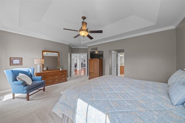 bedroom featuring visible vents, ornamental molding, light carpet, a raised ceiling, and a ceiling fan