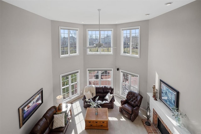 carpeted living room with recessed lighting, a towering ceiling, and ceiling fan