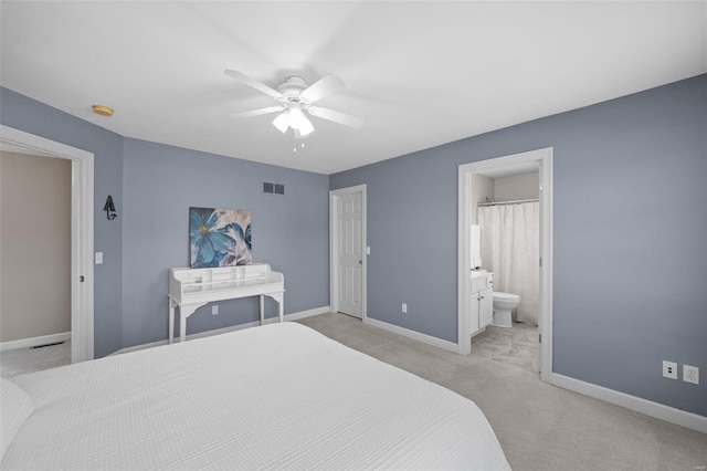 bedroom with baseboards, visible vents, ensuite bath, ceiling fan, and light carpet