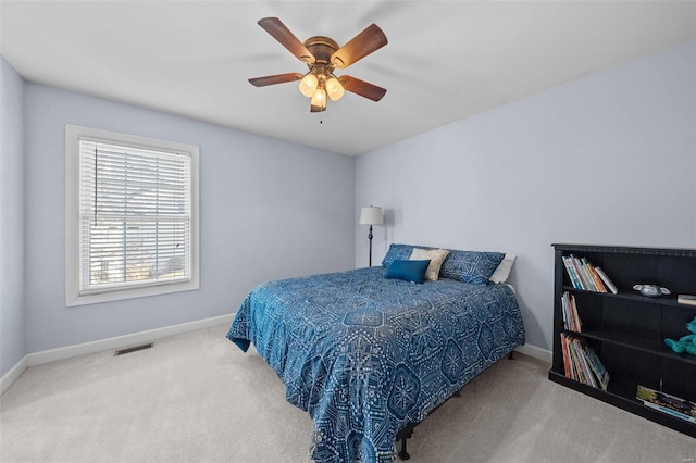 bedroom with visible vents, a ceiling fan, baseboards, and carpet floors