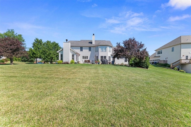 exterior space with a yard and a chimney