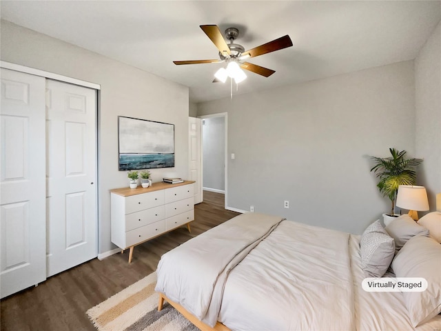 bedroom featuring a closet, dark wood-style flooring, baseboards, and a ceiling fan