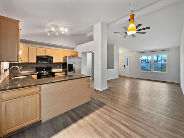 kitchen with decorative backsplash, light brown cabinets, a sink, a peninsula, and black appliances