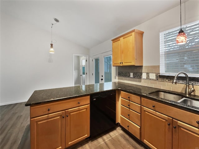 kitchen with lofted ceiling, a peninsula, a sink, black dishwasher, and decorative backsplash