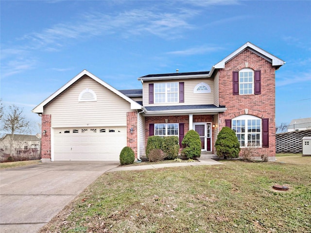 traditional home featuring a front yard, brick siding, driveway, and an attached garage