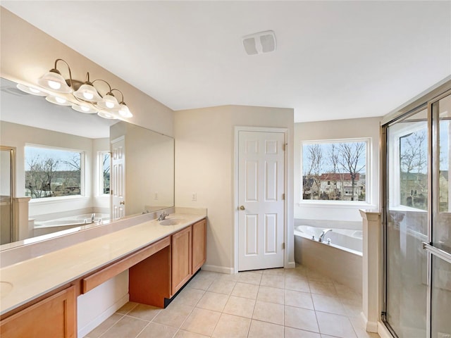 full bathroom with double vanity, tile patterned floors, a sink, a garden tub, and a wealth of natural light