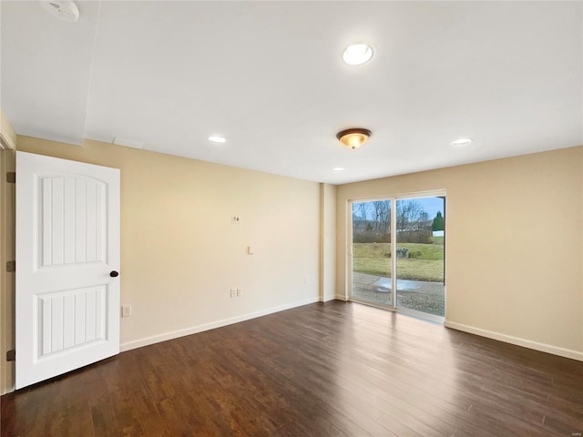 empty room with baseboards, dark wood finished floors, and recessed lighting