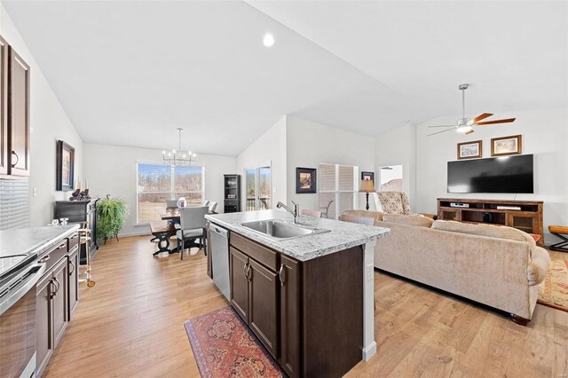 kitchen with light wood-type flooring, a sink, stainless steel appliances, lofted ceiling, and dark brown cabinets