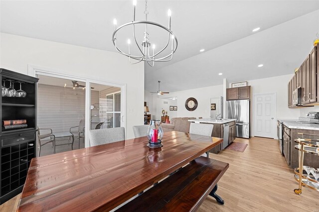 dining area with recessed lighting, light wood-style floors, and ceiling fan with notable chandelier